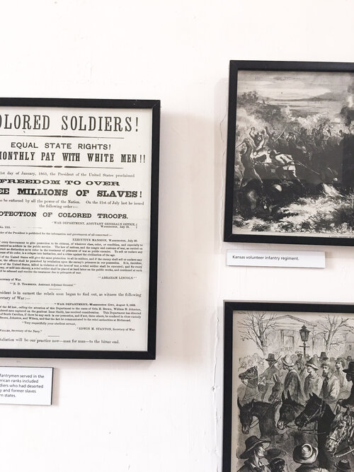 Black and white photos on the wall of black soldiers at the black history buffalo soldiers exhibition at Fort Point