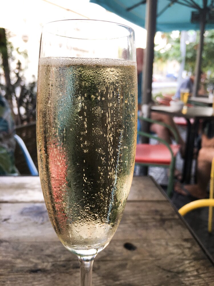 Cold glass of bubbly cava outside on a sunny day