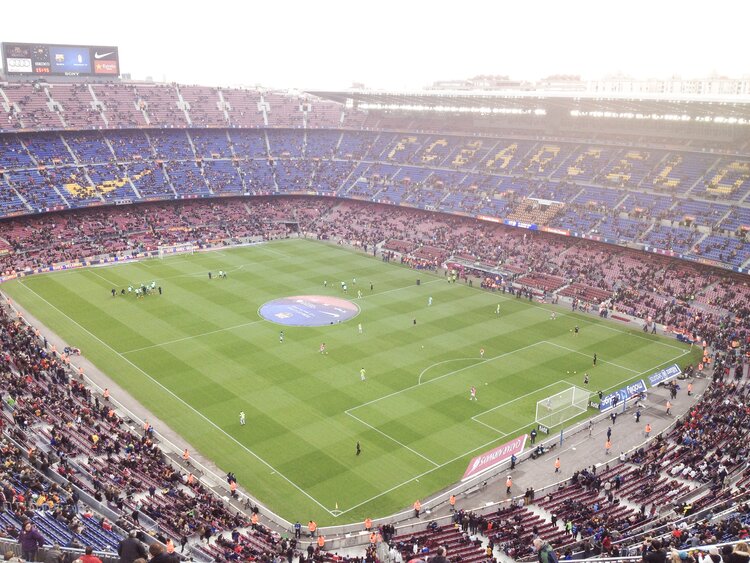 Crowded Camp Nou stadium on a sunny day