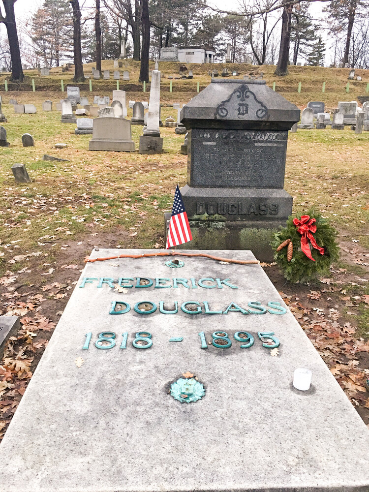 Black history hero Frederick Douglass graves with small American flag at Mount Hope Cemetery in Rochester New York