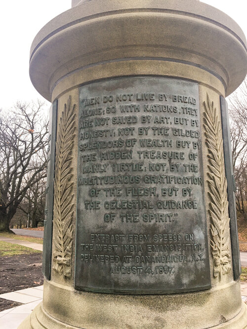 Fredrick Douglass quote on side of monument in Rochester New York on a rainy day