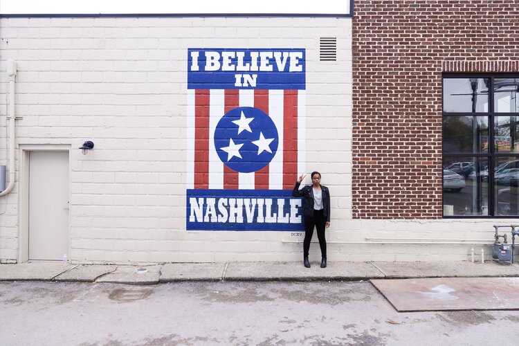 Kim standing in front of the I Believe in Nashville mural in Nashville Tennessee