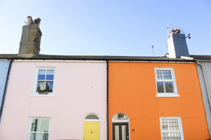 Light pink apartment connected with bright orange apartment on a sunny day in Brighton England in Europe