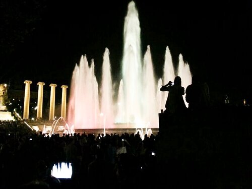 Magic Fountain of Montjuic at night with white waters and colorful lights