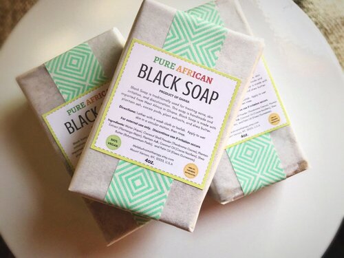 3 bars of wrapped Pure African Black Soap on a white table-2