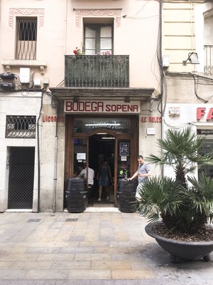 Outside store front and upper apartment of Bodega Sopena in Barcelona in the afternoon