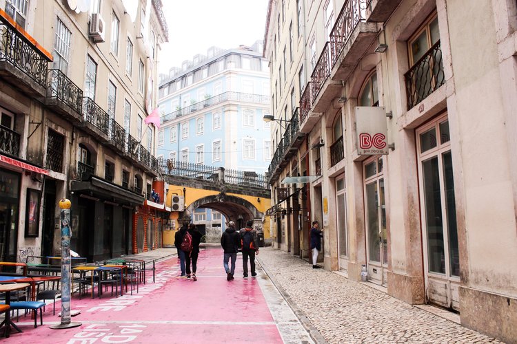 Rua Nova do Carvalho pink road with yellow bridge and blue building