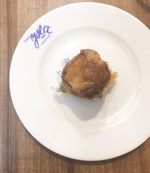 Sweet pionono on a small white plate with the blue Casa Ysla logo on the side