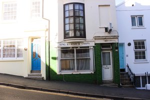 Quiet street with closed fish and chips shop in Brighton England in Europe on a sunny day