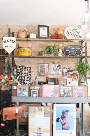 Small display of old photographs and magazines at women owned business BLK MKT Vintage in Brooklyn New York