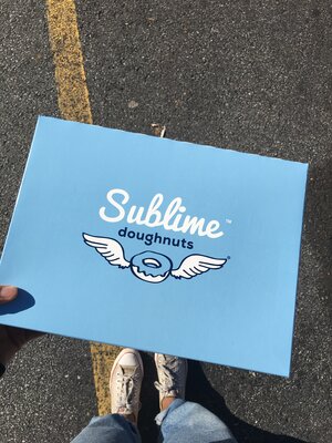 Blue Sublime doughnut box with Kim’s white converse shoes in the background