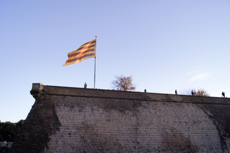 Top of Montjuic Castle in Barcelona with catalan flag waving in the air