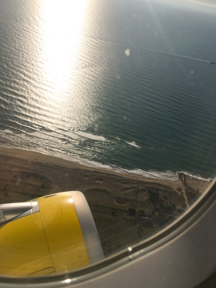 View of beach through airplane window