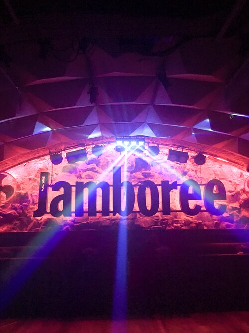 Jamboree nightclub sign with pink and blue neon lights at night