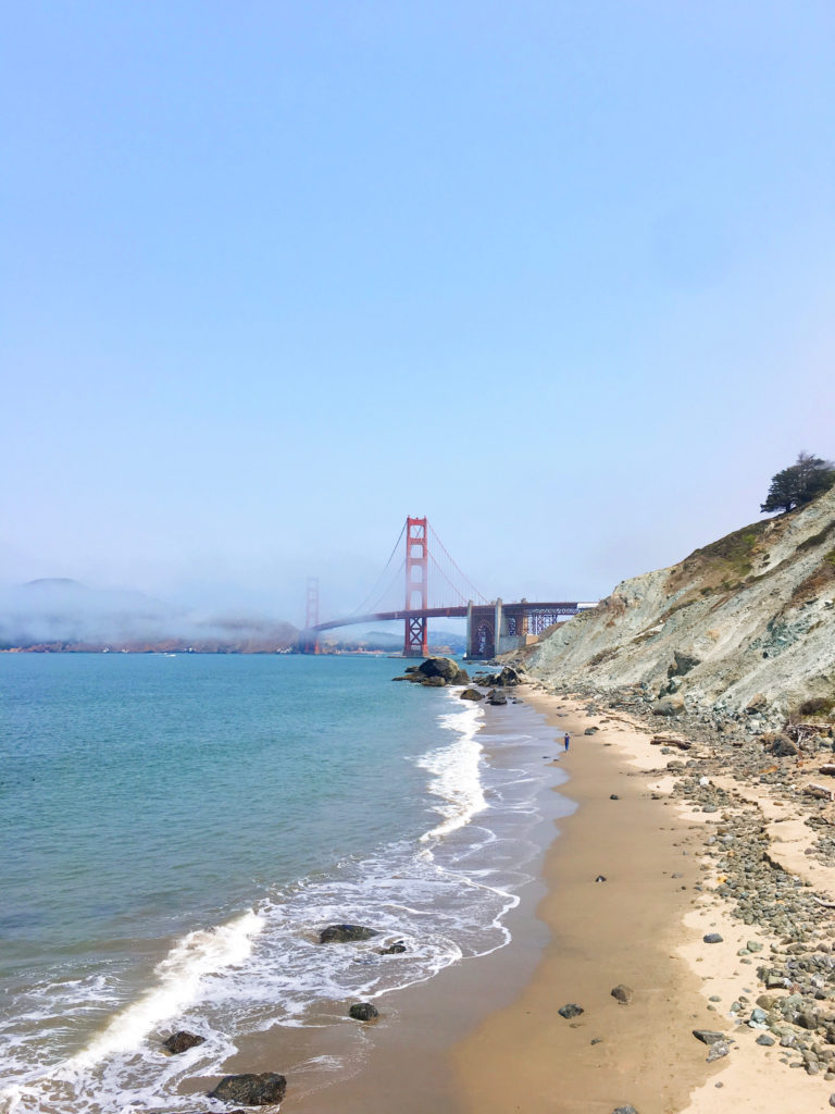 Baker Beach in San Francisco, California with the Golden Gate Bridge in the background on a sunny day