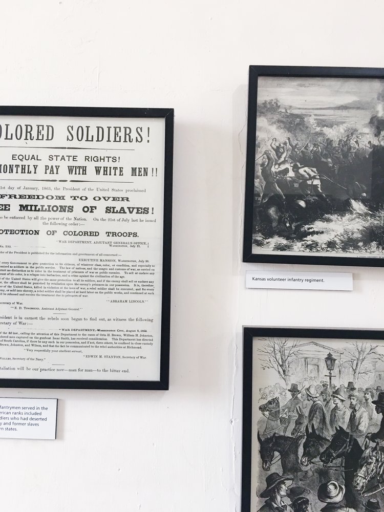 Black and white photos on the wall of black soldiers at the black history buffalo soldiers exhibition at Fort Point 2