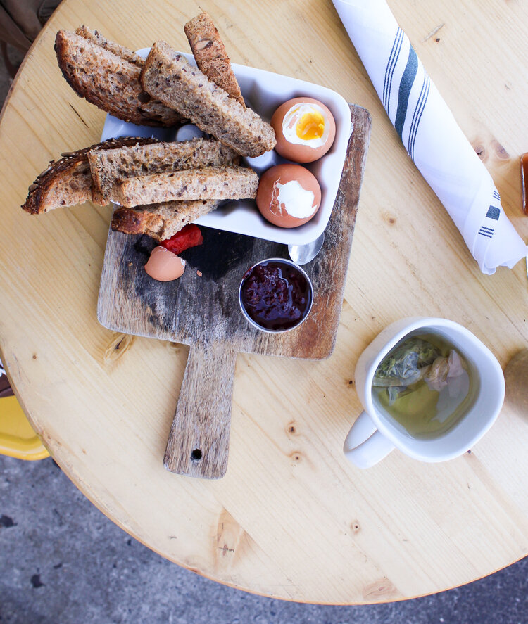 Boiled eggs with whole wheat toast sticks and green tea at The Butcher’s Daughter in New York