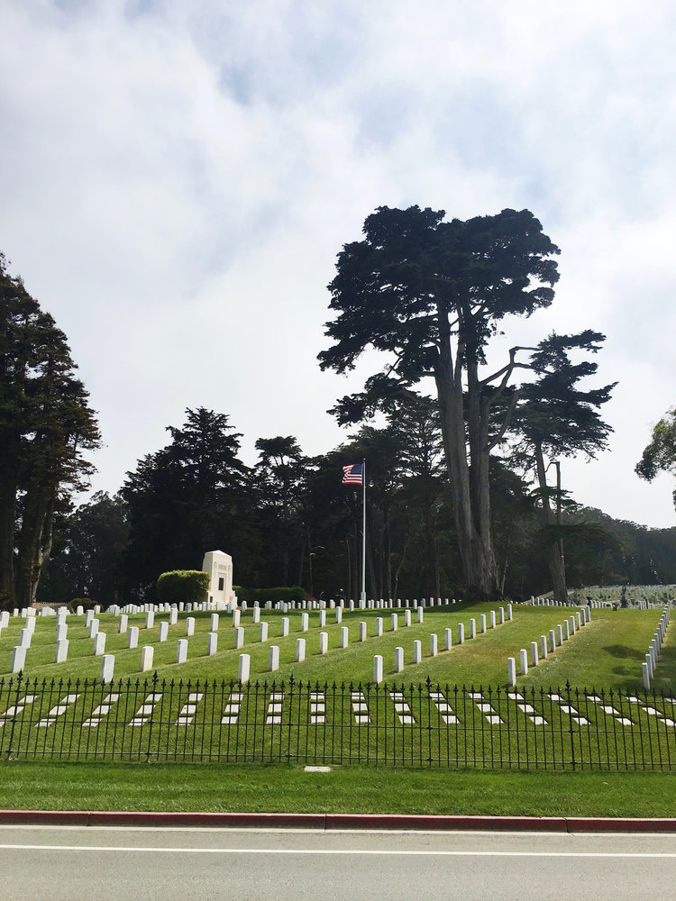 Grave stones at the San Francisco National Cemetery in San Francisco California with American flag