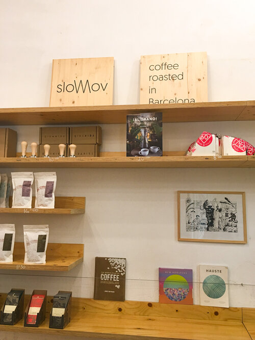 Shelf with coffee chocolate and tools at Slow Mov coffee shop in Barcelona
