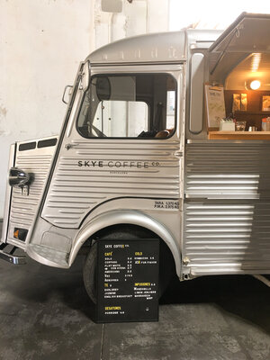 The front of Skye coffee shop silver truck with the menu propped in front of the front tire in Barcelona Spain