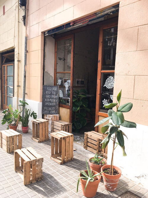 Outside of Espai Joliu coffee shop in Barcelona Spain on a sunny day