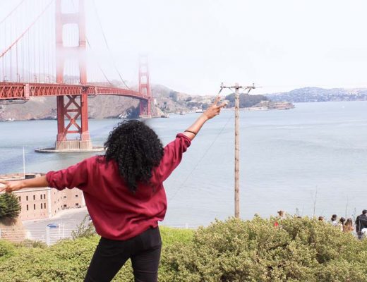 Kim making a peace sign in front of the golden gate bridge