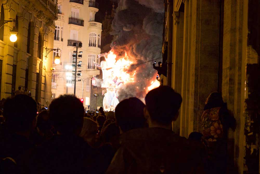 Crowd of people watching a burning float in Valencia Spain day trip from Barcelona