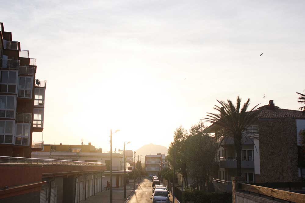 Sunset over the streets with parked cars in Costa brava on a day trip from Barcelona