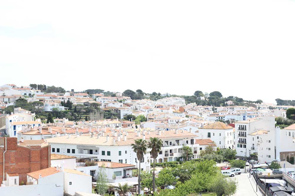 White houses in Costa Brava with the skyline on a sunny day during one of the best Barcelona day trips.