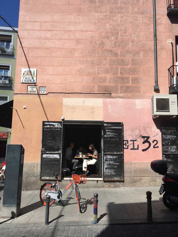 Two people enjoying lunch at a restaurant in Madrid Spain on a sunny day