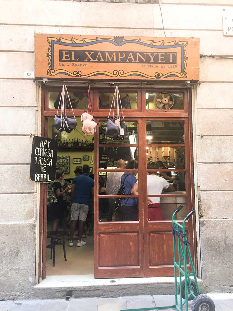 Outside the front entrance of one of the best tapas bars in Barcelona El Xampanyet on a sunny day
