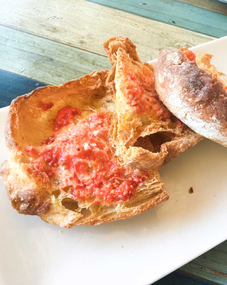 Plate of crispy tomato bread at one of Barcelona's best tapas bar