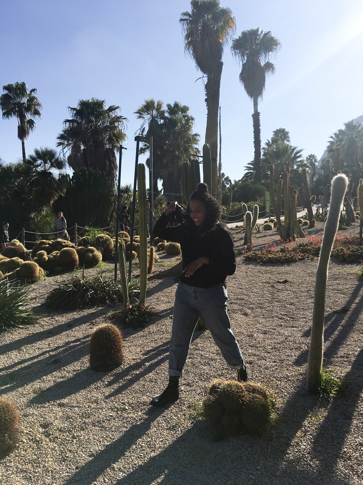 Kim taking photos on a cactus farm on a sunny day how to pack a carry on