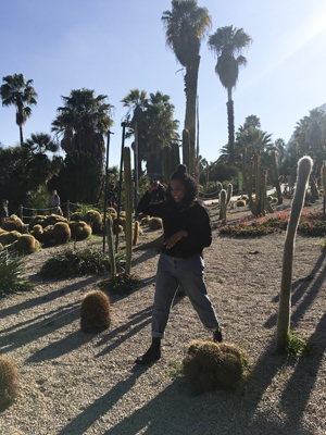 Kim taking photos on a cactus farm on a sunny day